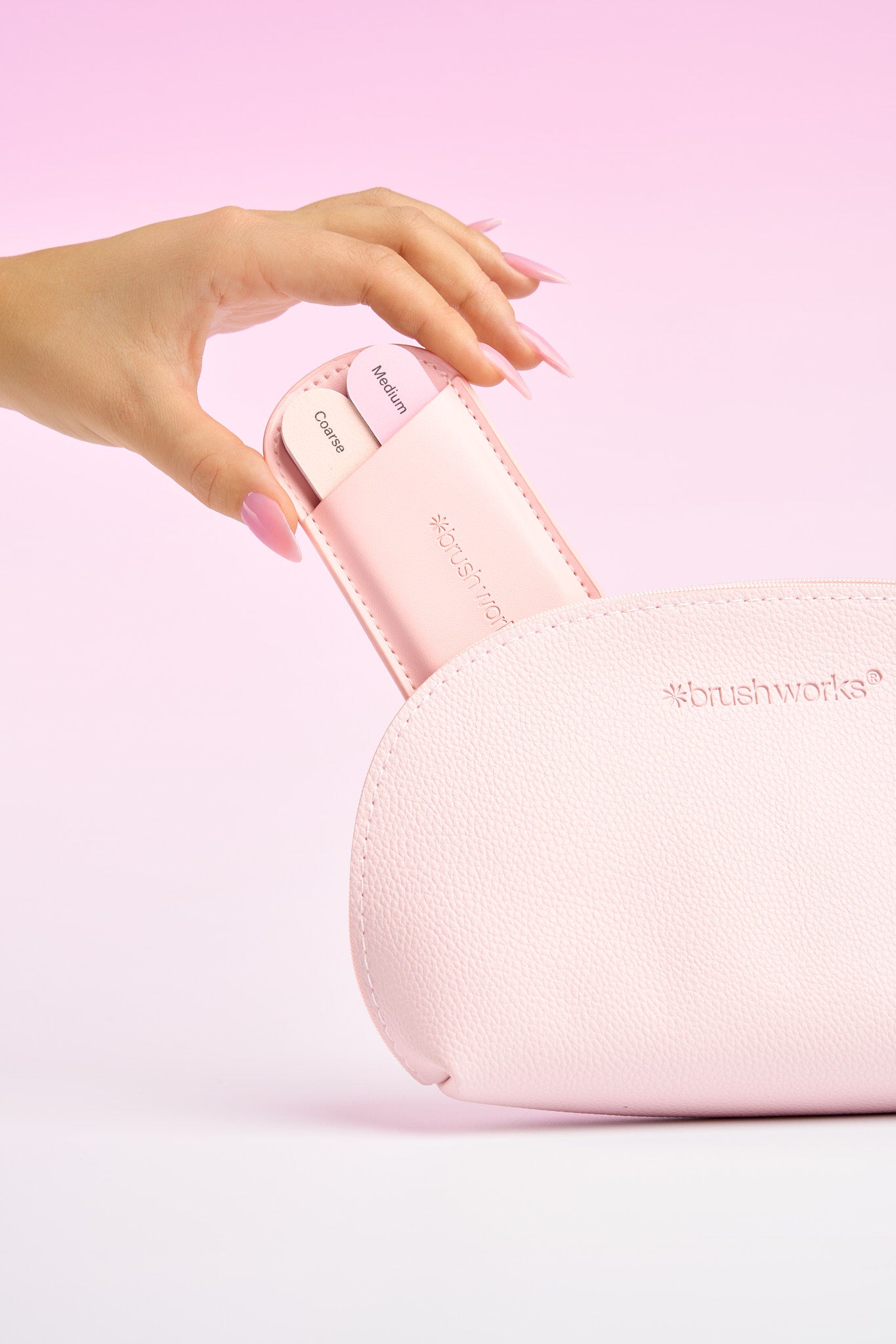 Brushworks nail-care products beside a pink beauty pouch