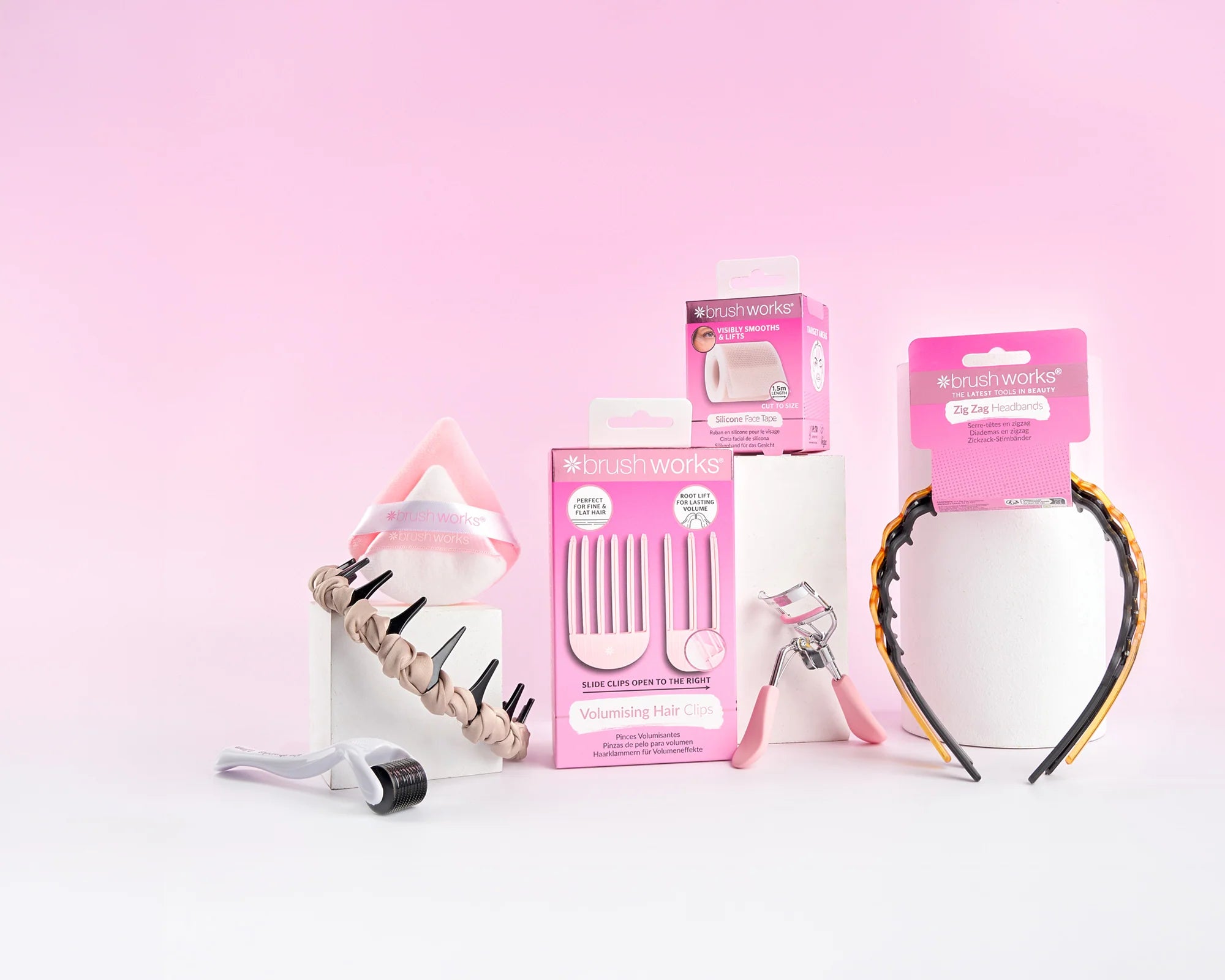Brushworks beauty tools arranged on a soft pink backdrop