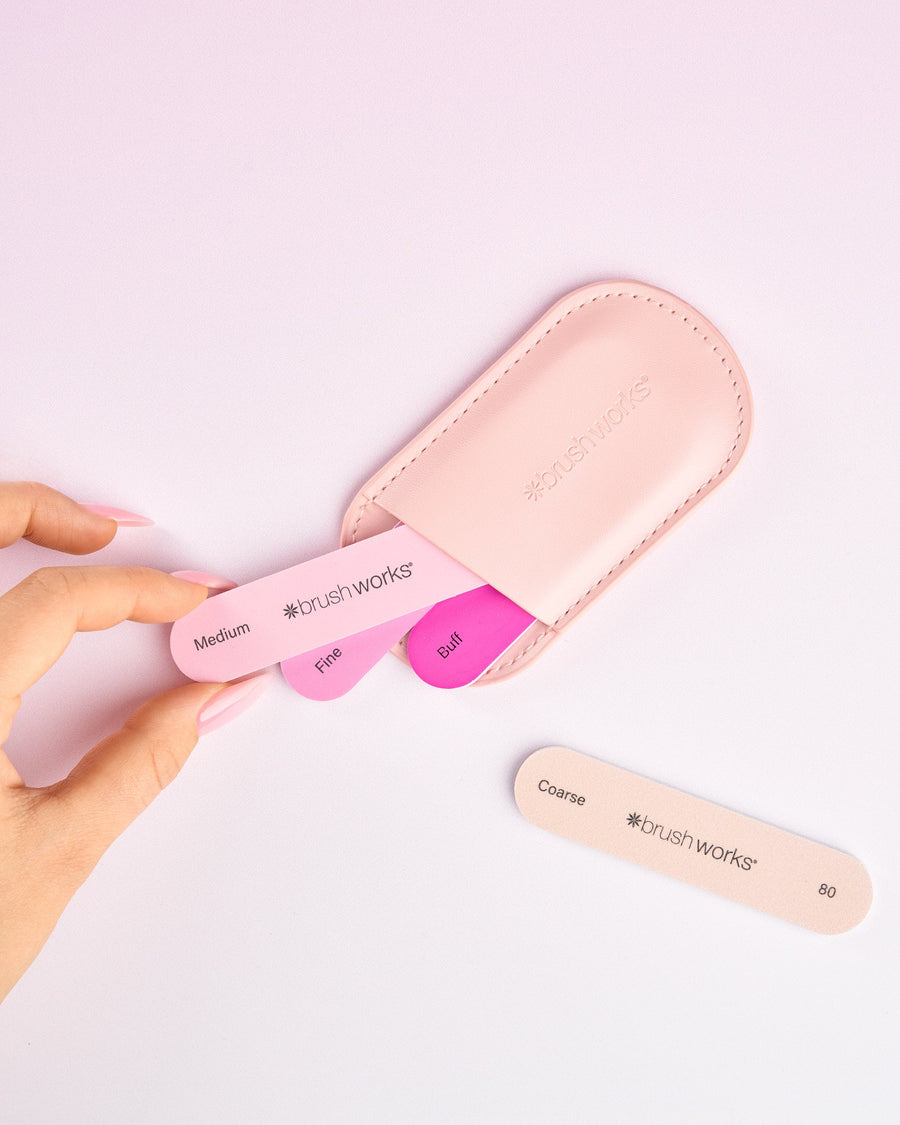 Brushworks Travel Manicure File Set arranged on a pink background.